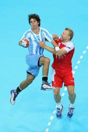 DIA 2: Diego Esteban Simonet, de Argentina se ve presionado por Ingimundur Ingimundarson, de Islandia durante las preliminares varoniles de Handball.
