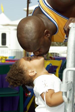 El jugador estrella de los Lakers Shaquille O'Neal, le da un beso a su princesita durante una práctica.