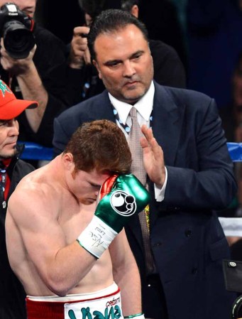 LAS VEGAS, NV - SEPTEMBER 14: Golden Boy Promotions CEO Richard Schaefer looks on as boxer Canelo Alvarez bows his head in the ring before taking on Floyd Mayweather Jr. in their WBC/WBA 154-pound title fight at the MGM Grand Garden Arena on September 14, 2013 in Las Vegas, Nevada. (Photo by Ethan Miller/Getty Images)