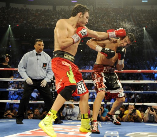 LAS VEGAS, NV - SEPTEMBER 15: Julio Cesar Chavez Jr. (L) lands a left to the head of Sergio Martinez in the tenth round of their WBC middleweight title fight at the Thomas & Mack Center on September 15, 2012 in Las Vegas, Nevada. (Photo by Jeff Bottari/Getty Images)
