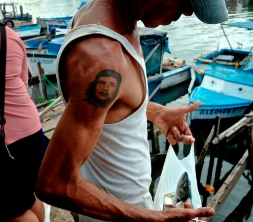 Un pescador revisa su pesca del día en un muelle local de La Habana.