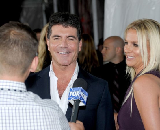 En el lugar 18:<br />Simon Cowel, el presentador de TV, acompañado en esta imagen de otra integrante de la lista Forbes, Britney Spears (posición 6).