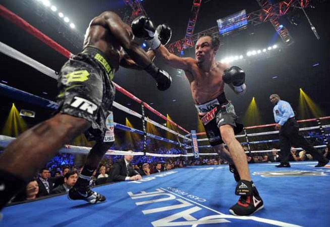 LAS VEGAS, NV - OCTOBER 12: Juan Manuel Marquez (R) swings at WBO welterweight champion Timothy Bradley Jr. during their bout at the Thomas & Mack Center on October 12, 2013 in Las Vegas, Nevada. Bradley won in a split-decision. Bradley won in a split-decision. (Photo by Jeff Bottari/Getty Images)