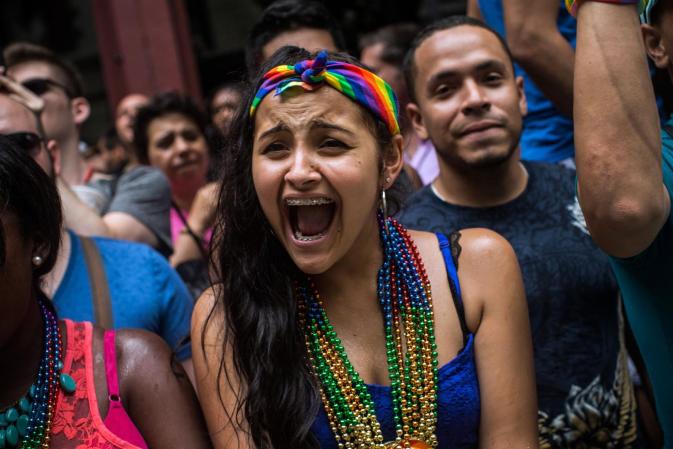 NEW YORK, NY - JUNE 30: Revelers watch the New York Gay Pride Parade on June 30, 2013 in New York City. This year's parade was a particularly festive occasion, due to the recent Supreme Court Ruling that it was unconstitutional to ban gay marriage. (Photo by Andrew Burton/Getty Images)