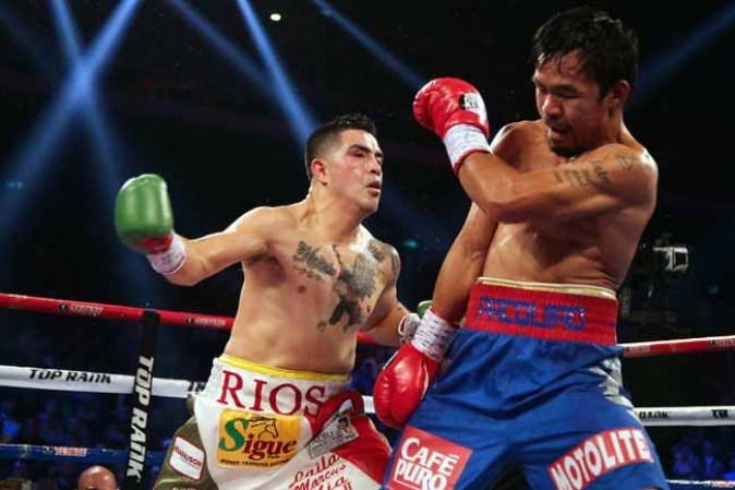 MACAU - NOVEMBER 24: Manny Pacquiao (R) of the Philippines fights with Brandon Rios of the U.S. during their 'Clash in Cotai' WBO International Welterweight title bout on November 24, 2013 in Macau. (Photo by Nicky Loh/Getty Images)