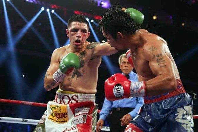 MACAU - NOVEMBER 24: Manny Pacquiao (R) of the Philippines fights with Brandon Rios of the U.S. during their 'Clash in Cotai' WBO International Welterweight title bout on November 24, 2013 in Macau. (Photo by Nicky Loh/Getty Images)