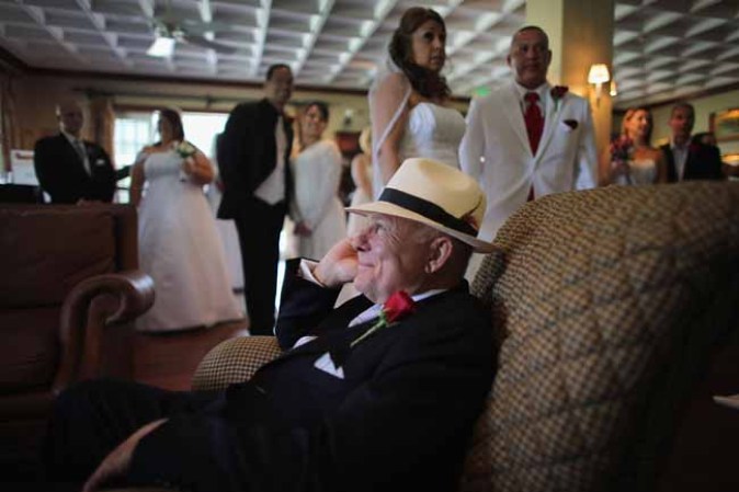 WEST PALM BEACH, FL - FEBRUARY 14: Paul Preston sits in a chair as he waits to be wed during a group Valentine's day wedding at the National Croquet Center on February 14, 2013 in West Palm Beach, Florida. The group wedding ceremony is put on by the Palm Beach Country Clerk & Comptroller's office and approximately 40 couples tied the knot. (Photo by Joe Raedle/Getty Images)
