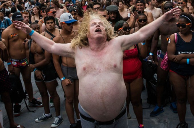 NEW YORK, NY - AUGUST 05: A man wearing only his underwear dances in front of a crowd in Times Square in an attempt to break the Guinness Book of World Records' record for "the most amount of people gathered in their underwear in the Times Square section of New York" on August 5, 2013 in New York City. Organizers were hoping to get 2,271 people to strip down to their underwear - the current record is 2,270. (Photo by Andrew Burton/Getty Images)