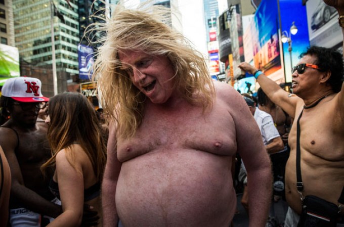 NEW YORK, NY - AUGUST 05: A man wearing only his underwear dances in front of a crowd in Times Square in an attempt to break the Guinness Book of World Records' record for "the most amount of people gathered in their underwear in the Times Square section of New York" on August 5, 2013 in New York City. Organizers were hoping to get 2,271 people to strip down to their underwear - the current record is 2,270. (Photo by Andrew Burton/Getty Images)