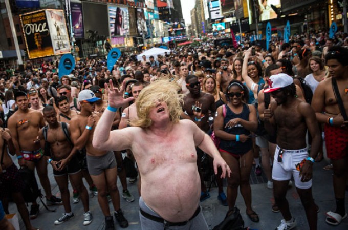 NEW YORK, NY - AUGUST 05: A man wearing only his underwear dances in front of a crowd in Times Square in an attempt to break the Guinness Book of World Records' record for "the most amount of people gathered in their underwear in the Times Square section of New York" on August 5, 2013 in New York City. Organizers were hoping to get 2,271 people to strip down to their underwear - the current record is 2,270. (Photo by Andrew Burton/Getty Images)