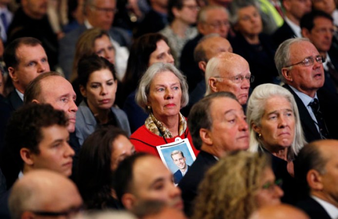 NEW YORK, NY - MAY 15: A woman wears a photograph of a victim of the September 11 2001 attacks on the World Trade Center around her neck during the opening ceremony for the National September 11 Memorial Museum at ground zero May 15, 2014 in New York City. The museum spans seven stories, mostly underground, and contains artifacts from the attack on the World Trade Center Towers on September 11, 2001 that include the 80 ft high tridents, the so-called "Ground Zero Cross," the destroyed remains of Company 21's New York Fire Department Engine as well as smaller items such as letter that fell from a hijacked plane and posters of missing loved ones projected onto the wall of the museum. The museum will open to the public on May 21. (Photo by Mike Segar-Pool/Getty Images)