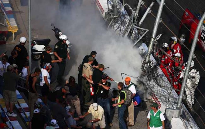 DAYTONA BEACH, FL - FEBRUARY 23: Track officials put out flames after an incident at the finish of the NASCAR Nationwide Series DRIVE4COPD 300 at Daytona International Speedway on February 23, 2013 in Daytona Beach, Florida. (Photo by Jonathan Ferrey/Getty Images)