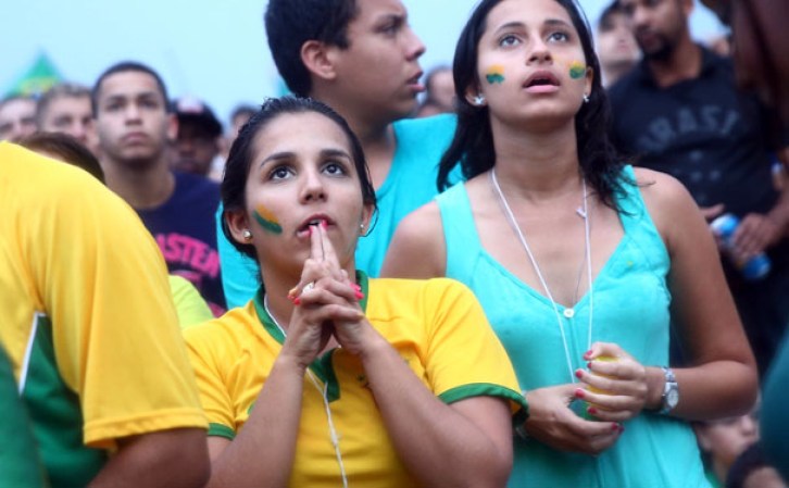 RIO DE JANEIRO, BRAZIL - JULY 08: Brazil fans watch the first half on Copacabana Beach during the 2014 FIFA World Cup semi-final match between Brazil and Germany on July 8, 2014 in Rio de Janeiro, Brazil. The winner advances to the final at the famed Maracana stadium. (Photo by Mario Tama/Getty Images)