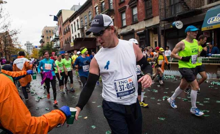 NEW YORK, NY - NOVEMBER 03: A man takes a cup of water while running the ING New York City Marathon on November 3, 2013 in New York City. With the Boston Marathon bombing from earlier this year still fresh in many minds, security is especially high this year at the New York City marathon. (Photo by Andrew Burton/Getty Images)