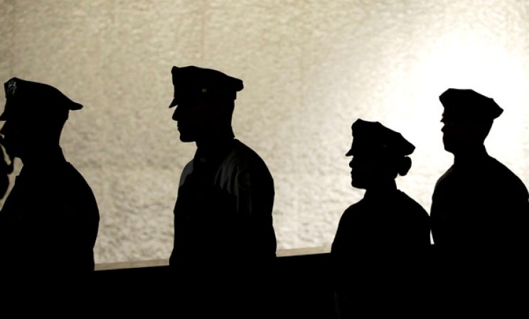 NEW YORK, NY - MAY 15: Uniformed officers walk to position at the start of the opening ceremony for the National September 11 Memorial Museum at ground zero May 15, 2014 in New York City. The museum spans seven stories, mostly underground, and contains artifacts from the attack on the World Trade Center Towers on September 11, 2001 that include the 80 ft high tridents, the so-called "Ground Zero Cross," the destroyed remains of Company 21's New York Fire Department Engine as well as smaller items such as letter that fell from a hijacked plane and posters of missing loved ones projected onto the wall of the museum. The museum will open to the public on May 21. (Photo by John Angelillo-Pool/Getty Images)