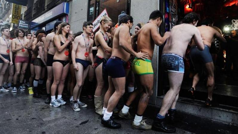 MADRID, SPAIN - JANUARY 02: Semi-nude shoppers enter a Spanish clothes outlet for free clothes during a promotion on January 2, 2012 in Madrid, Spain. The first one hundred semi-nude shoppers were alllowed free clothes on the first day of January sales. (Photo by Denis Doyle/Getty Images)