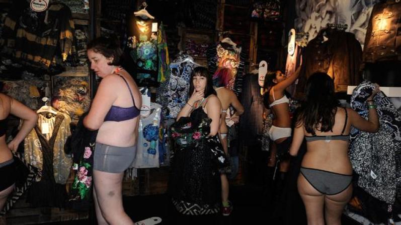 MADRID, SPAIN - JANUARY 02: Semi-nude shoppers select free clothes during a promotion in a Spanish clothes outlet on January 2, 2012 in Madrid, Spain. The first one hundred semi-nude shoppers were alllowed free clothes on the first day of January sales. (Photo by Denis Doyle/Getty Images)