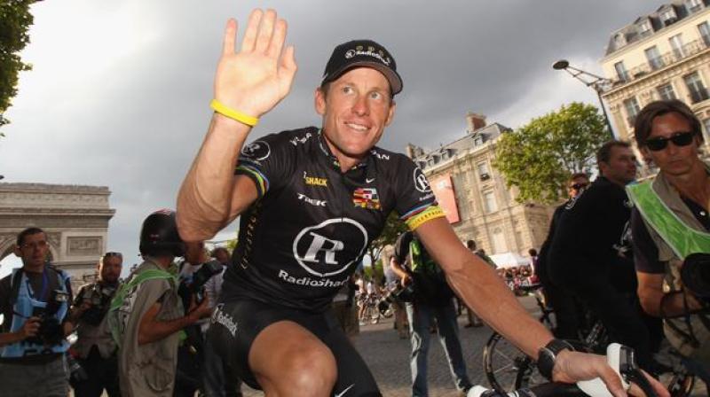 PARIS - JULY 25: Lance Armstrong of team Radioshack waves to fans after the twentieth and final stage of Le Tour de France 2010, from Longjumeau to the Champs-Elysees in Paris on July 25, 2010 in Paris, France. (Photo by Bryn Lennon/Getty Images) *** Local Caption *** Lance Armstrong