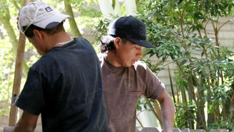SAN RAFAEL, CA - MAY 23: Illegal immigrant Jose Augustine (R) of Guatemala carries a slab of stone while working on a landscaping job May 23, 2007 in San Rafael, California. Jose came to the United States from Guatemala and is currently living and working as a landscaper in Marin County, California. Jose is married with one child who still lives in Guatemala. The Senate immigration bill currently being debated in Washington would lay out a scenario for Jose and his family to become citizens, which could include paying a fine and returning to ones country of origin. (Photo by Justin Sullivan/Getty Images) *** Local Caption *** Jose Augustine