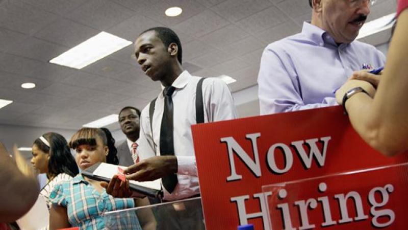 MIAMI, FL - AUGUST 23: Ronald Baker speaks with a job recruiter as he looks for a job at a job fair in the James L. Knight Center on August 23, 2011 in Miami, Florida. The job fair, known as "For the People" Jobs Initiative was put on by the Congressional Black Caucus and is part of a nationwide series of job fairs and town hall meetings. (Photo by Joe Raedle/Getty Images)