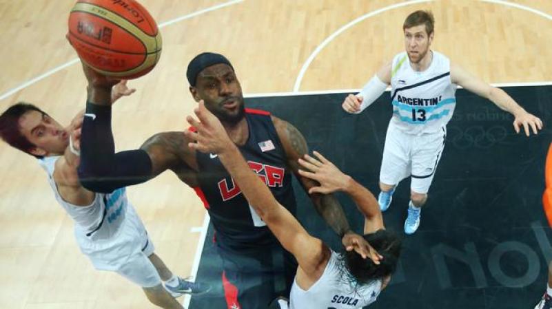 LONDON, ENGLAND - AUGUST 06: (EDITORS NOTE: A polarizing filter was used for this image.) Lebron James #6 of United States goes to the hoop against Luis Scola #4 of Argentina during the Men's Basketball Preliminary Round match on Day 10 of the London 2012 Olympic Games at the Basketball Arena on August 6, 2012 in London, England. (Photo by Christian Petersen/Getty Images)
