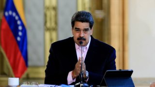 In this March 26, 2020, handout picture released by the Venezuelan Presidency, Venezuelan President Nicolas Maduro speaks during a televised announcement at Miraflores Presidential Palace in Caracas.