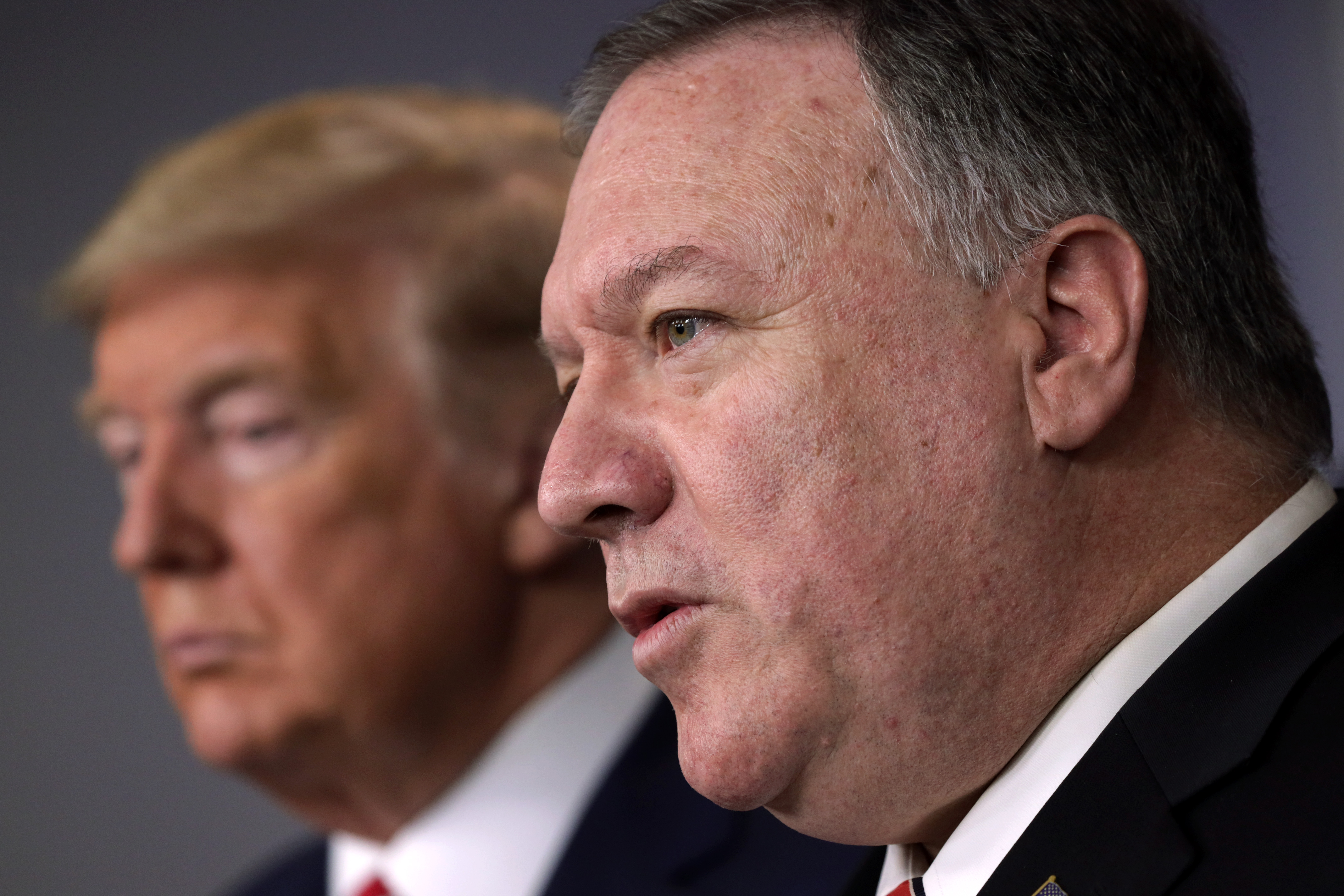 WASHINGTON, DC - MARCH 20: U.S. Secretary of State Mike Pompeo speaks as President Donald Trump listens during a news briefing on the latest development of the coronavirus outbreak in the U.S. at the James Brady Press Briefing Room at the White House March 20, 2020 in Washington, DC. With deaths caused by the coronavirus rising and foreseeable economic turmoil, the Senate is working on legislation for a $1 trillion aid package to deal with the COVID-19 pandemic. President Trump announced that tax day will be delayed from April 15 to July 15.