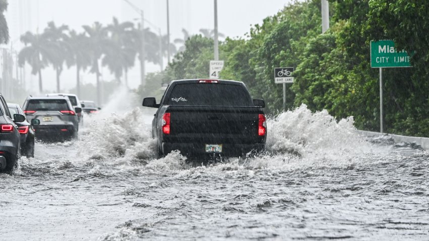 A car drives through the flooded street during heavy rain and wind as tropical storm Eta approaches the south of Florida, in Miami, Florida on November 9, 2020. – Tropical storm Eta brought strong winds and torrential rain to Cuba on Sunday after having cut a destructive and deadly path through parts of Central America and southern Mexico. (Photo by CHANDAN KHANNA / AFP) (Photo by CHANDAN KHANNA/AFP via Getty Images)