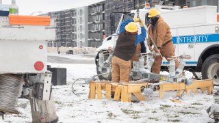 Workers repair a power line in Austin, Texas, U.S., on Wednesday, Feb. 18, 2021. Texas is restricting the flow of natural gas across state lines in an extraordinary move that some are calling a violation of the U.S. Constitutions commerce clause.