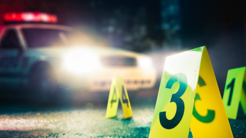 police car at a crime scene with evidence markers / high contrast image