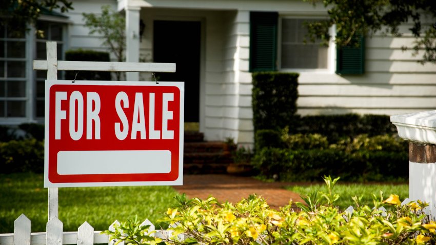 For sale sign outside a family house