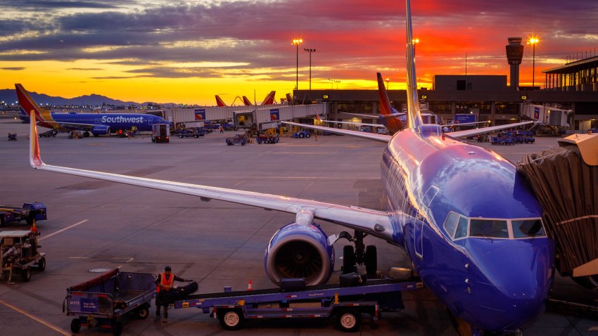 Southwest Airlines Boeing 737 airplanes prepare for their next flight at Phoenix Sky Harbor International Airport, at sunset on March 21, 2019.