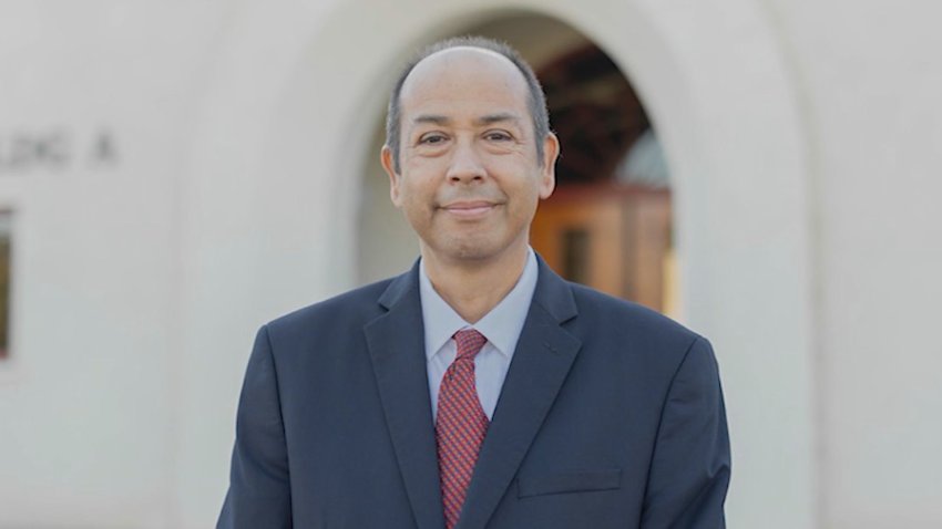A man in a blue suit and red tie
