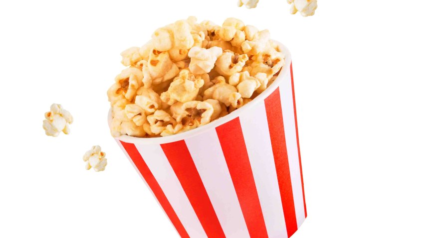 Popcorn in a bowl on a white background. Little court to go to the movies. Popcorn combos for the movies. Side view of pop corn.