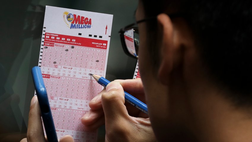 NEW YORK, NY – OCTOBER 23:  Customers fill out Mega Millions lottery tickets outside of a convenience store in Lower Manhattan, October 23, 2018 in New York City. The $1.6 billion Mega Millions prize to be drawn Tuesday night is set to be the largest lottery prize in U.S. history. (Photo by Drew Angerer/Getty Images)