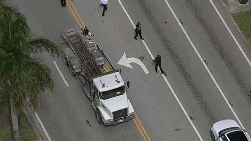 A woman who was pushing a stroller was struck and killed by a dumpster truck in Miami while the child she was with was rushed to the hospital Wednesday, officials said.