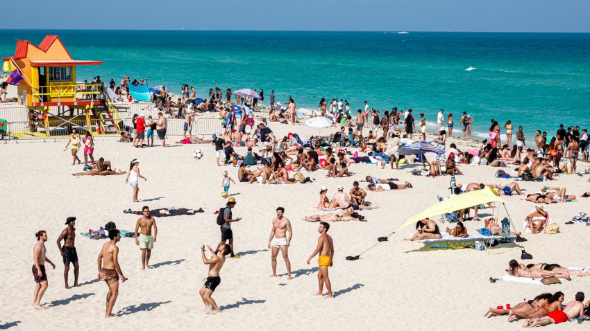 Miami Beach, Florida, crowded beach with sunbathers, lifeguard station. (Photo by: Jeffrey Greenberg/Universal Images Group via Getty Images)