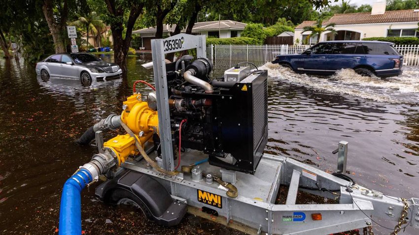 A Miami-Dade pump works to move water from the street after heavy rains on June 13, 2024, in Miami Shores, Florida. (D.A. Varela/Miami Herald/Tribune News Service via Getty Images)