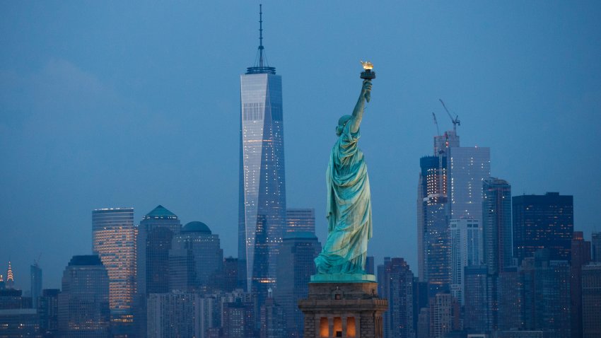 NEW YORK, NY – SEPTEMBER 8: in The Statue of Liberty stands in the foreground as Lower Manhattan is viewed at dusk, September 8, 2016 in New York City. New York City is preparing to mark the 15th anniversary of the September 11 terrorist attacks. (Photo by Drew Angerer/Getty Images)