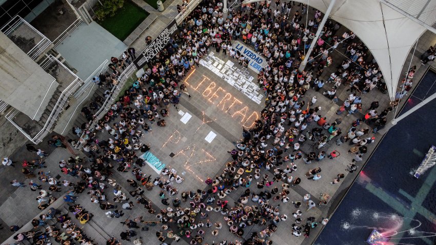 TOPSHOT – Aerial view shows people surrounding lit candles forming the words ‘Freedom and Peace’ during a vigil called by the opposition demanding freedom for political prisoners arrested during protest following the contested re-election of Venezuelan President Nicolas Maduro in Caracas, August 8, 2024. Venezuela’s opposition warned of a potential mass exodus of migrants if President Nicolas Maduro remains in power following his contested reelection, with the US calling on the strongman not to arrest protest leaders. (Photo by Hirsaid GOMEZ / AFP) (Photo by HIRSAID GOMEZ/AFP via Getty Images)