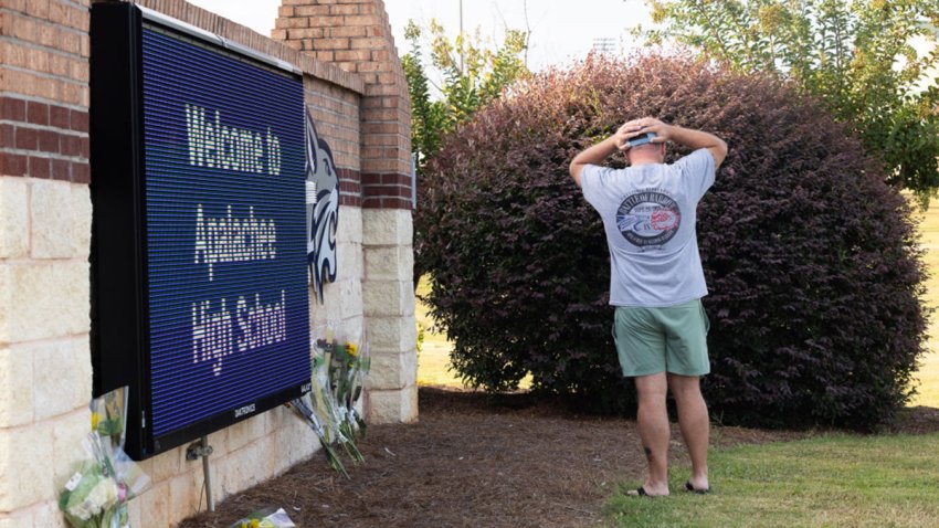 WINDER, GEORGIA – SEPTEMBER 5: Wes Robertson, area county teacher and former teacher of slain student Mason Schermerhorn, lays flowers at the entrance sign of Apalachee High School on September 5, 2024 in Winder, Georgia. Two students and two teachers were shot and killed at the school on September 4, and a 14-year-old suspect, who is a student at the school, is in custody.  (Photo by Jessica McGowan/Getty Images)