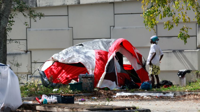 People have set up tents in a small homeless encampment in the Park and Ride parking lot off Broward Boulevard in Fort Lauderdale, Florida, on Wednesday, Feb. 28, 2024. Gov. Ron DeSantis signed a controversial bill Wednesday that forbids homeless people from sleeping in public places and prevents local governments from allowing them to stay there unless the state authorizes them to do so. (Mike Stocker/South Florida Sun Sentinel/Tribune News Service via Getty Images)