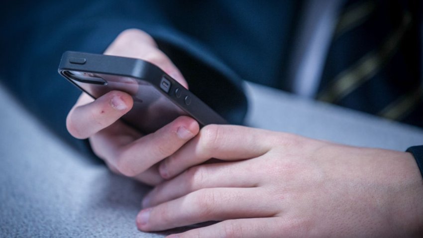 BRISTOL, UNITED KINGDOM – FEBRUARY 26: A 12-year-old school boy looks at a iPhone screen on February 26, 2015 in Bristol, England. The amount of time children spend on screens each day rocketed during the Covid pandemic by more than 50 per cent, the equivalent of an extra hour and twenty minutes. Researchers say that unmoderated screen time can have long-lasting effects on a child’s mental and physical health. Recently TikTok announced that every account belonging to a user below age 18 have a 60-minute daily screen time limit automatically set. (Photo by Matt Cardy/Getty Images)