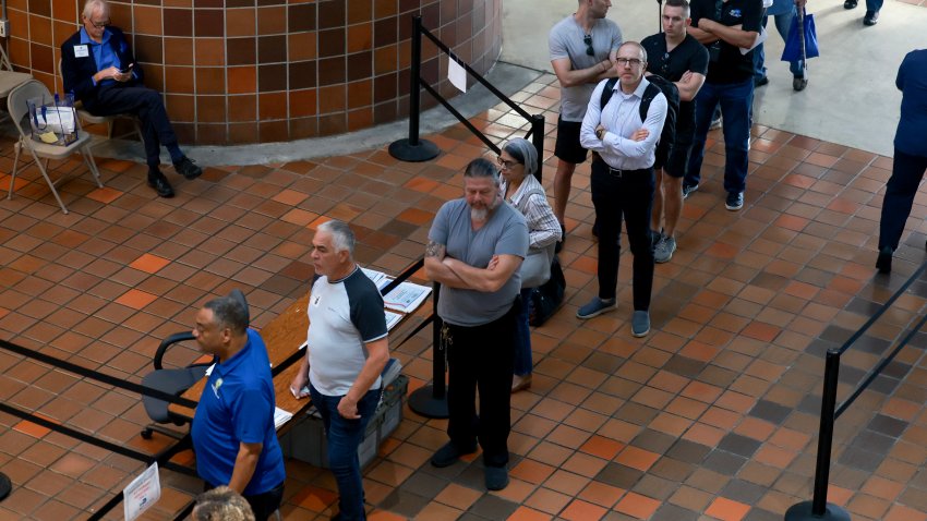 MIAMI, FLORIDA – OCTOBER 21: Voters wait in line to cast their ballot at a polling station set up at the Stephen P. Clark Center as early voting begins on October 21, 2024, in Miami, Florida. Early voting runs from Oct. 21 through Nov. 3 in Miami-Dade and Broward. People head to the polls to decide, among other races, the next president of the United States. (Photo by Joe Raedle/Getty Images)