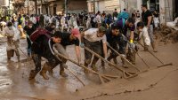 MASSANASSA, SPAIN – NOVEMBER 09: Volunteers and residents clear mud from street as the area recovers from last week’s widespread flooding on November 09, 2024 in the municipality of Massanassa Valencia, Spain. A week after the floods, Spanish authorities confirmed that at least 214 people had died, mostly in the Valencia region, amid the flooding that swept eastern and southern parts of the country starting on Tuesday. The intense rainfall event is known as a “cold drop” or DANA weather system. (Photo by David Ramos/Getty Images)