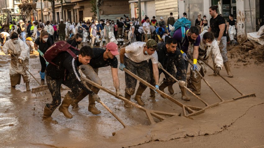 MASSANASSA, SPAIN – NOVEMBER 09: Volunteers and residents clear mud from street as the area recovers from last week’s widespread flooding on November 09, 2024 in the municipality of Massanassa Valencia, Spain. A week after the floods, Spanish authorities confirmed that at least 214 people had died, mostly in the Valencia region, amid the flooding that swept eastern and southern parts of the country starting on Tuesday. The intense rainfall event is known as a “cold drop” or DANA weather system. (Photo by David Ramos/Getty Images)