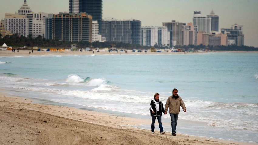 MIAMI BEACH- JANUARY 07:  Ingeborg Dilger and her husband, Klaus Ingeborg on vacation from Germany wear jackets as they enjoy the cool weather on the beach on January 7, 2010 in Miami Beach, Florida. Florida is expected to experience cold temperatures throughout the week.  (Photo by Joe Raedle/Getty Images)