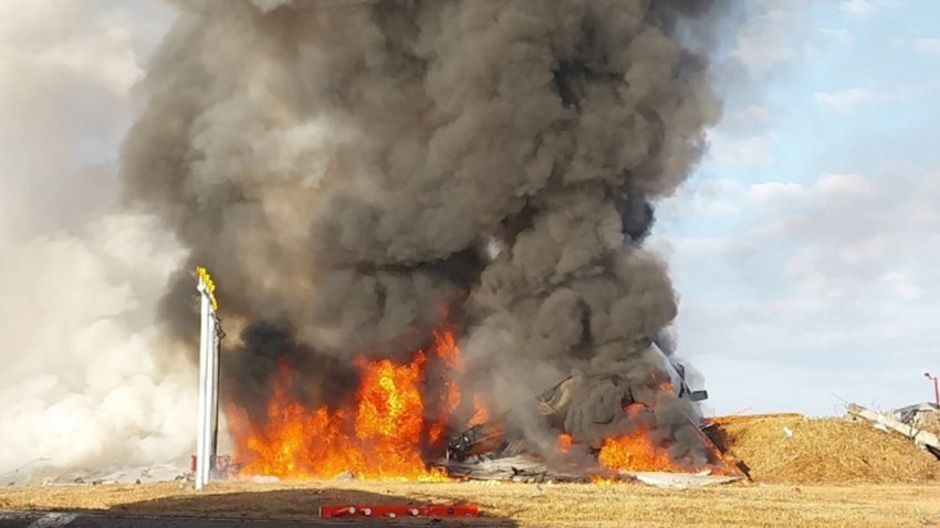 MUAN-GUN, SOUTH KOREA – DECEMBER 29: (EDITOR’S NOTE: This Handout image was provided by a third-party organization and may not adhere to Getty Images’ editorial policy.) In this handout photo provided by the South Korean National Fire Agency, Jeju Air Flight 7C2216 burns after skidding off the runway at Muan International Airport on December 29, 2024 in Muan-gun, South Korea. According to reports, Jeju Air Flight 7C2216 was carrying 175 passengers and six crew members when it attempted to land without landing gear. The Boeing 737 overran the runway and exploded after colliding with a wall. According to South Korean authorities, there are at least 64 fatalities and two survivors rescued from the crash with the casualty count is expected to rise. (Photo by South Korean National Fire Agency via Getty Images)