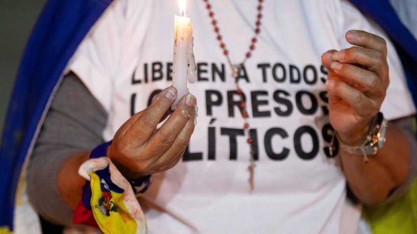 Foto de archivo de una mujer que sostiene una vela durante una vigilia por los “presos políticos” en la Universidad Central de Venezuela (UCV), en Caracas. EFE/ Ronald Peña