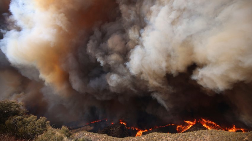 Columnas de humo se alzan mientras el incendio Hughes arde en Castaic, California, el miércoles 22 de enero de 2025. (AP Foto/Ethan Swope)